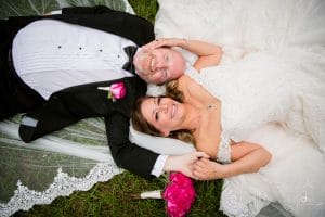 bride and groom laying in grass fun wedding photo idea savannah ga