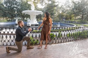 surprise proposal in savannah ga at forsyth park fountain with trees