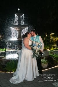 mackey house wedding savannah ga photographer night photos off camera flash garden white dress blue tie blue and white flowers wedding flowers - fountain - lighting up the water behind them, bigger bride photos, plus size bride